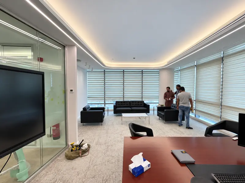 Office seating, glazed partitions and perimeter ceiling details.