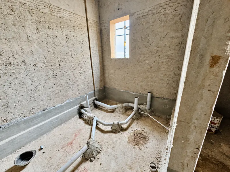 Wet-area drainage and perimeter preparation during construction.