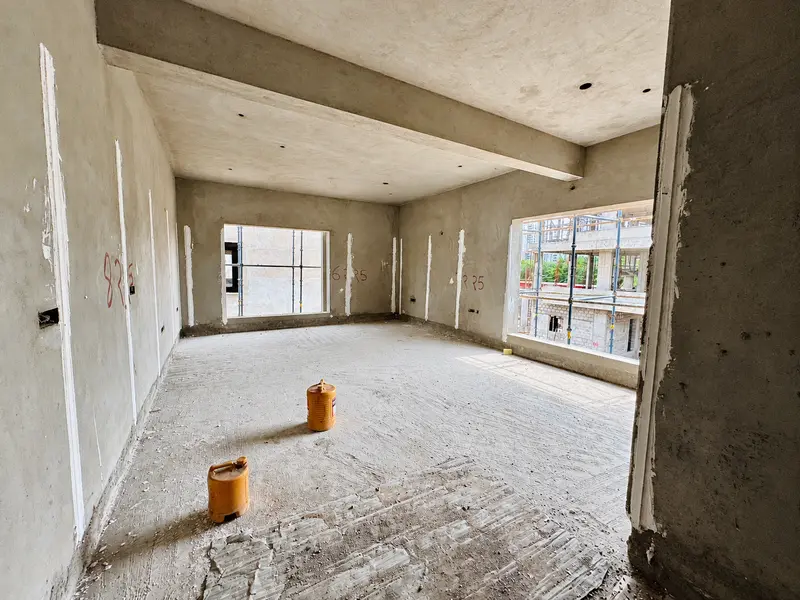 Plastered walls and prepared openings ahead of final finishes.