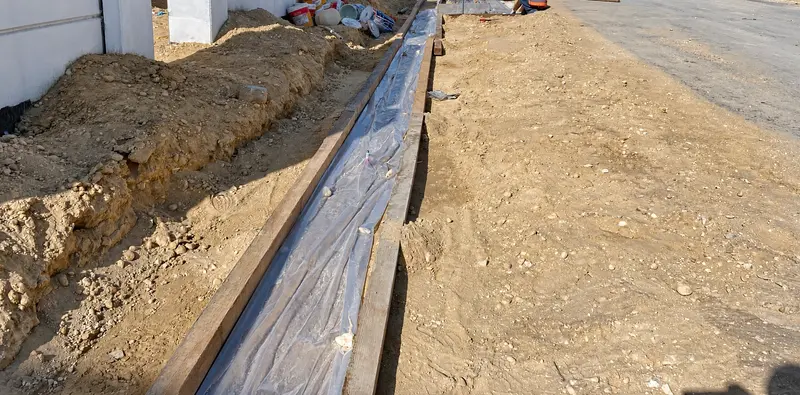 Formwork and lining preparation alongside external works.