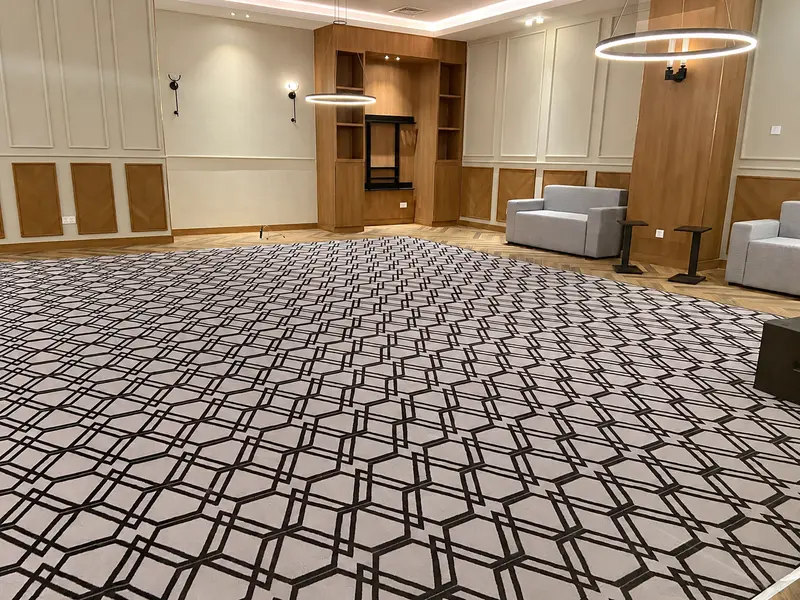 Timber panelling, patterned carpet and ring pendant lighting.
