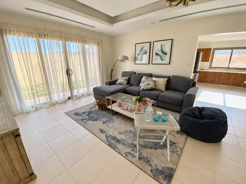 Living room finishes and the adjoining kitchen connection.