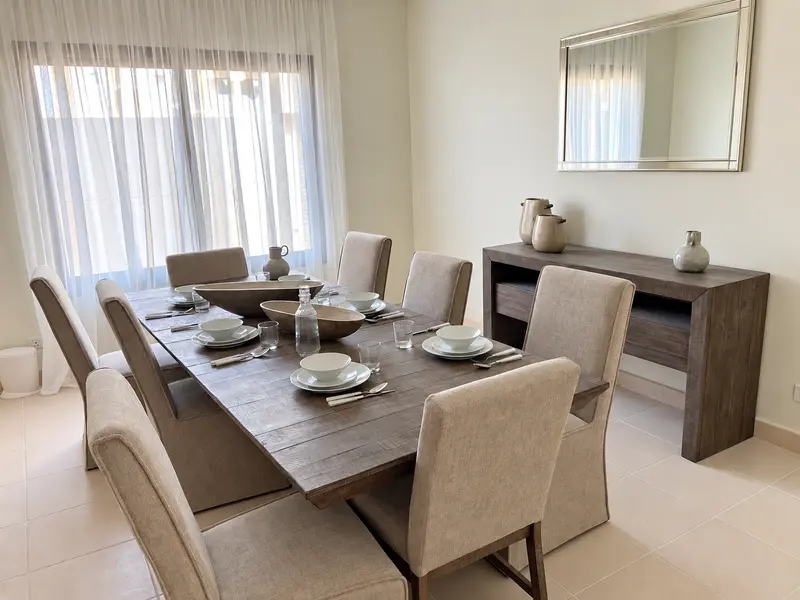 Dining furniture, sideboard and coordinated interior finishes.