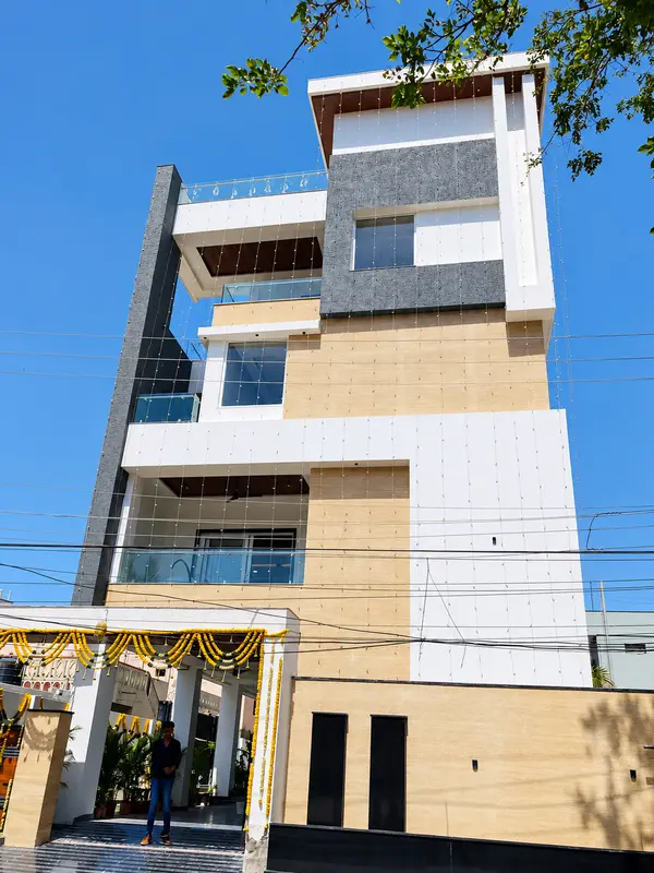 Exterior photograph with stone finishes, glass balustrades and balconies.