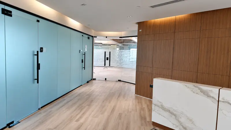 Reception area with timber wall finishes and a stone-front counter.